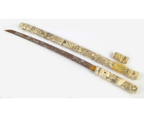 A Japanese Meiji period wakitashi with bone handle and scabbard, elaborately carved with numerous figures, length of blade 51