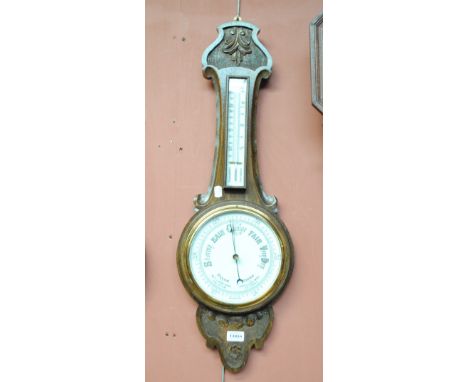 An early 20th century carved oak aneroid barometer, height 80cm. 