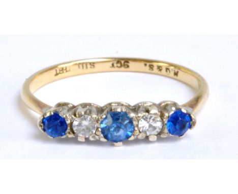 A 9ct yellow gold dress ring set with three blue scapolites and two clear glass stones in claw setting, size M, approx 1.3g.