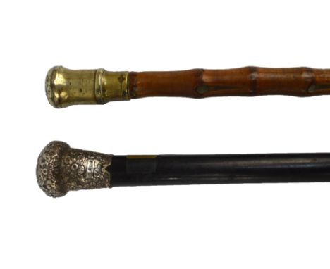 A Victorian hallmarked silver mounted ebonised walking cane and a further brass mounted bamboo example (2).