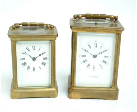 A late 19th century repeating brass carriage clock with swing loop handle, rectangular white enamelled dial set with Roman nu
