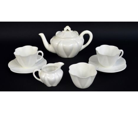 SHELLEY; a cream glazed tea for two set in 'Dainty' pattern comprising teapot, two cups and saucers, jug and bowl, printed ma