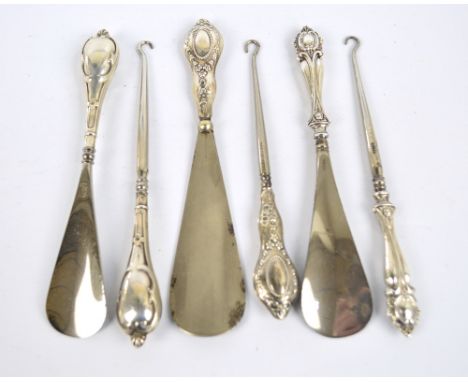 A Victorian hallmarked silver handled set of button hook and shoe horn decorated with stylised C-scroll motifs, E.S. Barnsley