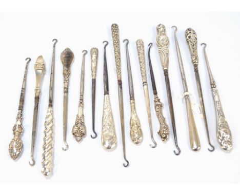 Fifteen medium sized and small button hooks with hallmarked silver sheath handles, including a figural example, an angel exam
