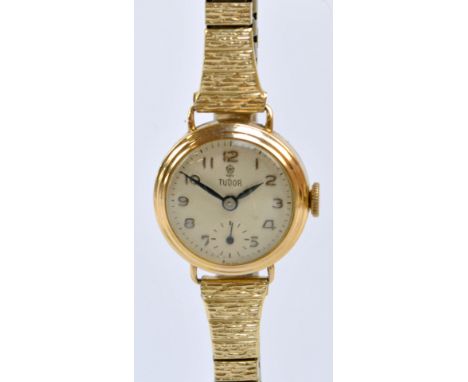 TUDOR FOR ROLEX; a 1950s 9ct gold cased manual wind lady's wristwatch, the circular dial set with Arabic numerals and with su