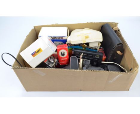 A small collection of vintage cameras to include Polaroid, Kodak EK8 instant camera, Zenit, and a small group of accessories.