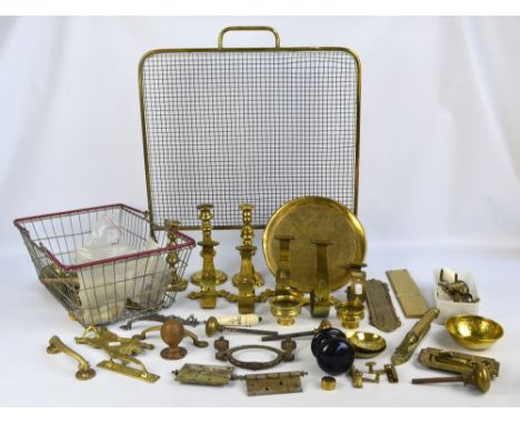 A quantity of predominantly brass metalware including a set of five wall mounted coat hooks, three candlesticks, a charger an