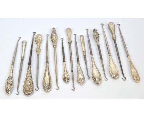 Fifteen medium sized button hooks with hallmarked silver sheath handles, including an example decorated with a bird on a nest