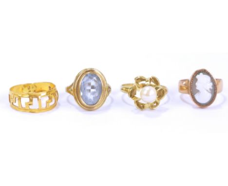 A 9ct yellow gold and simulated pearl set ring, and three further yellow metal dress rings (4).