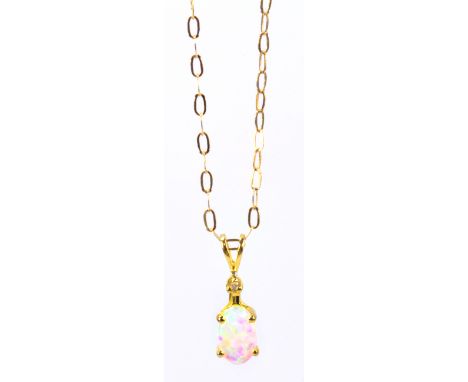 A 9ct yellow gold fine link chain supporting a tiny diamond and oval opal pendant. 