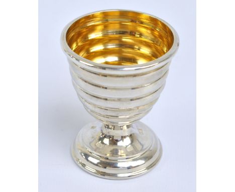 CHRISTOPHER HAMILITON; an Elizabeth II hallmarked silver egg cup with ribbed body and gilt washed interior, Birmingham 2015, 