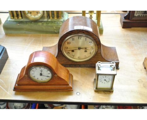 A 1920s oak mantel clock, width 38.5cm, a further mahogany example and a French carriage clock, height 11cm (3).