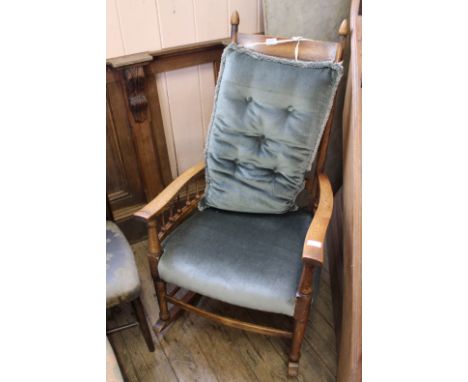 A 1920's oak ladder back rocking chair