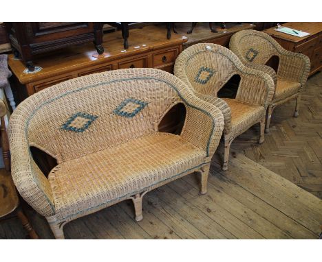 A two seater cane conservatory sofa and two single chairs 