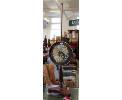 A Victorian mahogany pole fire screen with circular tapestry screen