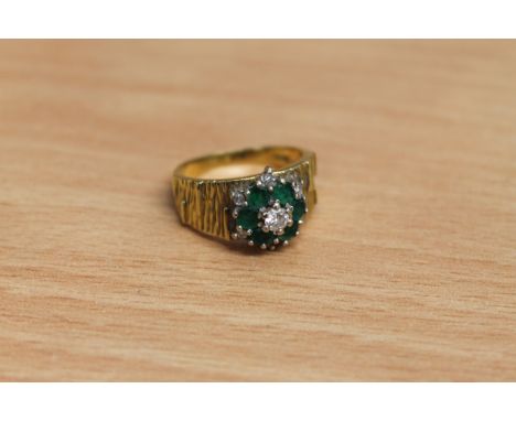 An 18ct gold emerald and diamond cluster ring, size L.