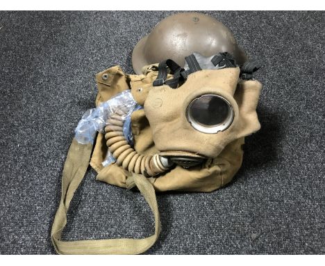 A crate containing WWII military helmet and respirator