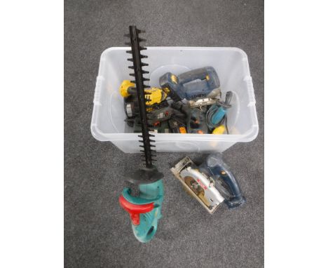 A box of power tools, hedger, saw etc