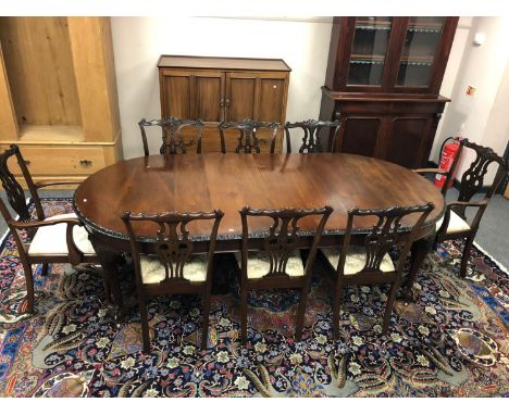 A good quality George III style mahogany extending dining table, with two leaves and winder (length 238cm), together with set