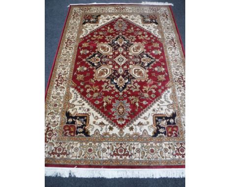 A Heriz carpet, on red ground, 2.3m x 1.6 m 