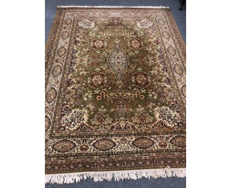A good quality machine made carpet of Persian Isfahan design, on green ground, 376cm by 274cm