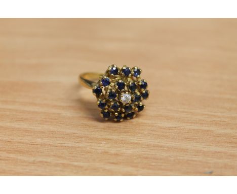 An 18ct gold sapphire and diamond cluster ring, 7.4g