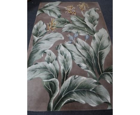 A contemporary carpet with leaf and flower decoration, 253cm by 160cm