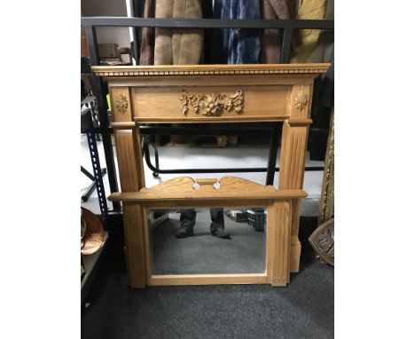 A light pine carved fire surround with mirror