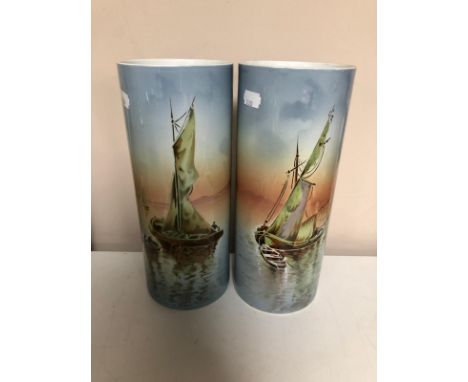 A pair of French ceramic vases depicting boats on still water 