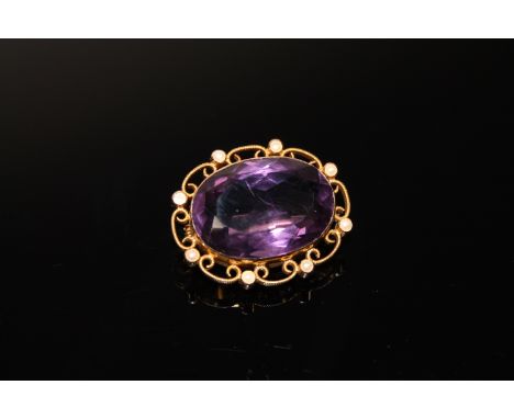 A 15ct gold brooch set with a large amethyst and seed pearls CONDITION REPORT: One seed pearl deficient.