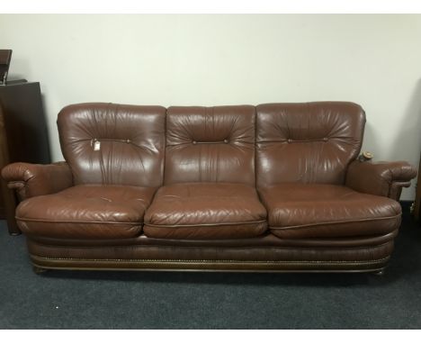 A brown leather button leather three seater settee