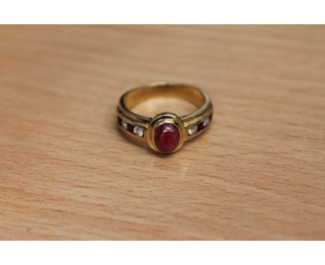 An 18ct gold ruby and diamond ring, the cabochon ruby set with brilliant cut diamonds and square cut ruby shoulders, size N.