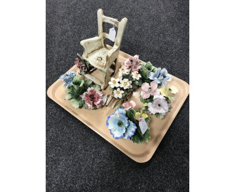 A Capo Di Monte ceramic model : Rocking chair with roses, height 21 cm, together with a pair of floral candlesticks, a wheelb