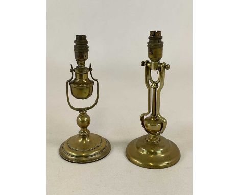 A pair of late 19th/early 20th century brass wall mounted gimballed light fittings, presumably for use on either railway or s