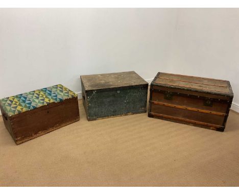 An early 20th century canvas covered travel trunk with wood and metal banding, height 49cm, width 90cm, depth 49cm, and two p