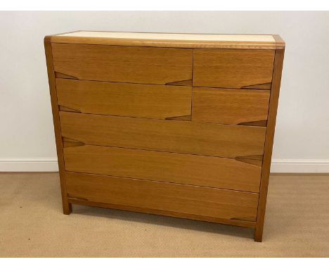 A modern and contemporary light oak chest of four short and three long drawers with a Formica insert to the top, height 117cm