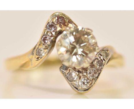 An 18ct yellow gold and diamond solitaire ring, the principal round brilliant cut stone weighing 0.72ct with diamond chips to