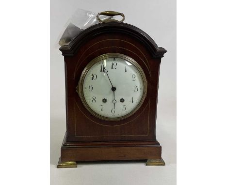A large Edwardian mahogany brass inlaid bracket clock, with French movement and Arabic numerals to the circular dial, raised 