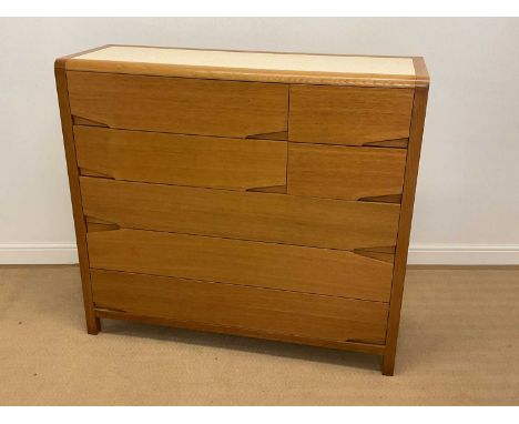 A modern and contemporary light oak chest of four short and three long drawers with a Formica insert to the top, height 117cm