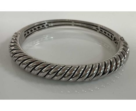 TI SENTO; a silver hinged oval bangle, internal width 60mm, approx 33g.
