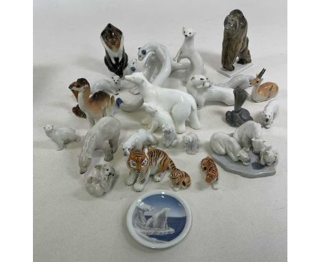 A collection of ceramic animal figures by Royal Copenhagen and Russian makers, including polar bears, camel, cobras, weasels,