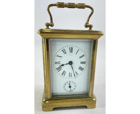 A circa 1900 French brass cased carriage clock, with Roman numerals to the white enamel dial above the subsidiary dial set wi