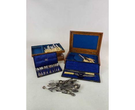 A small group of silver plated flatware contained within several cutlery boxes and also loose.