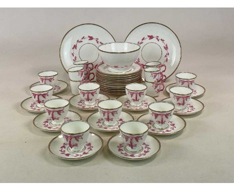 A 19th century part tea set with raised hand painted floral design in pink with gold border, comprising sugar bowl, various p