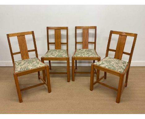 A set of four light oak Art Deco dining chairs with upholstered drop-in seats, height 86cm.