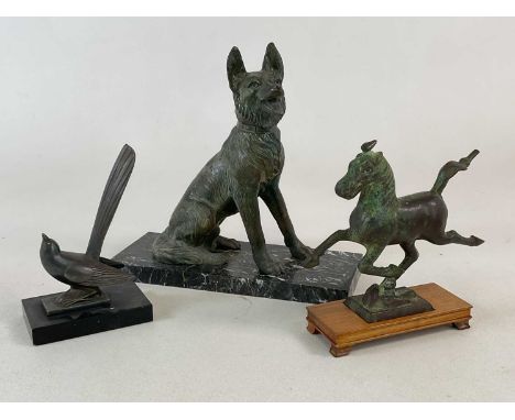 An Art Deco metal bird on a marble base, height 18.5cm, also a spelter model of an Alsatian seated on a marble base and a fur