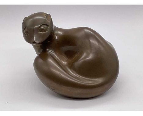 † RICHARD FISHER; a bronzed model of a stylised otter, signed, length 14.5cm.