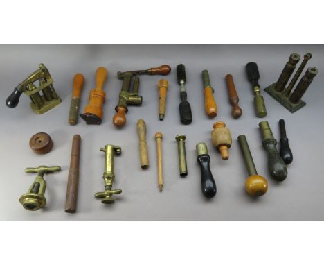 Ⓦ TWENTY-TWO RELOADING TOOLS FOR CARTRIDGES^ CIRCA 1880¦including two breech brushes^ one powder measure; ten boxwood cartrid