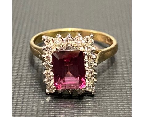 18ct hallmarked gold tourmaline and diamond cluster ring, the emerald cut tourmaline of 8x6mm approx, the diamonds of 0.02ct 