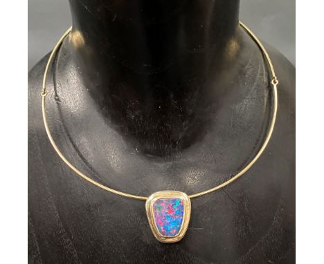 18ct gold torc pendant necklace, the pendant set with a boulder opal showing multiple colours, the pendant indistinctly signe